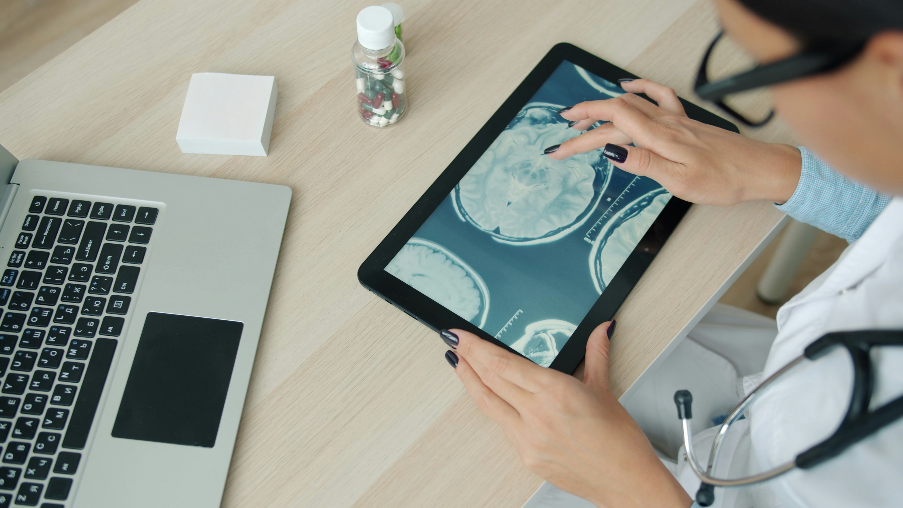 Clinician reviewing brain scan data on a tablet